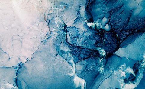 Blue acrylic ink. Marble texture. Frozen water surface with white snow effect. Fractured crystal ice rock abstract design. Mineral stone stained pattern. Nature art background.