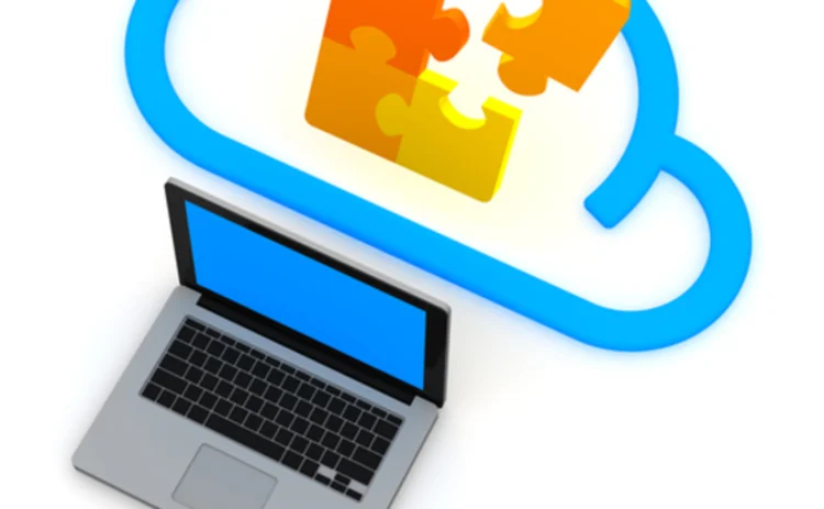 A graphic of a jigsaw in the cloud emerging from a laptop