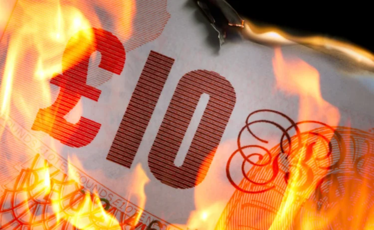 Ten pound note in flames